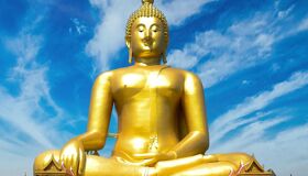 Golden Buddhist Statue shining under the sunlight, Thailand